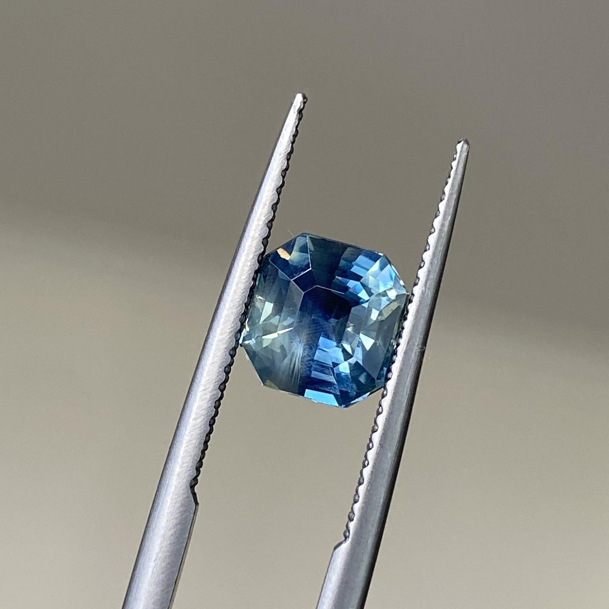 Bicolour teal sapphire showcasing the Asscher cut’s crisp geometry and dynamic color.