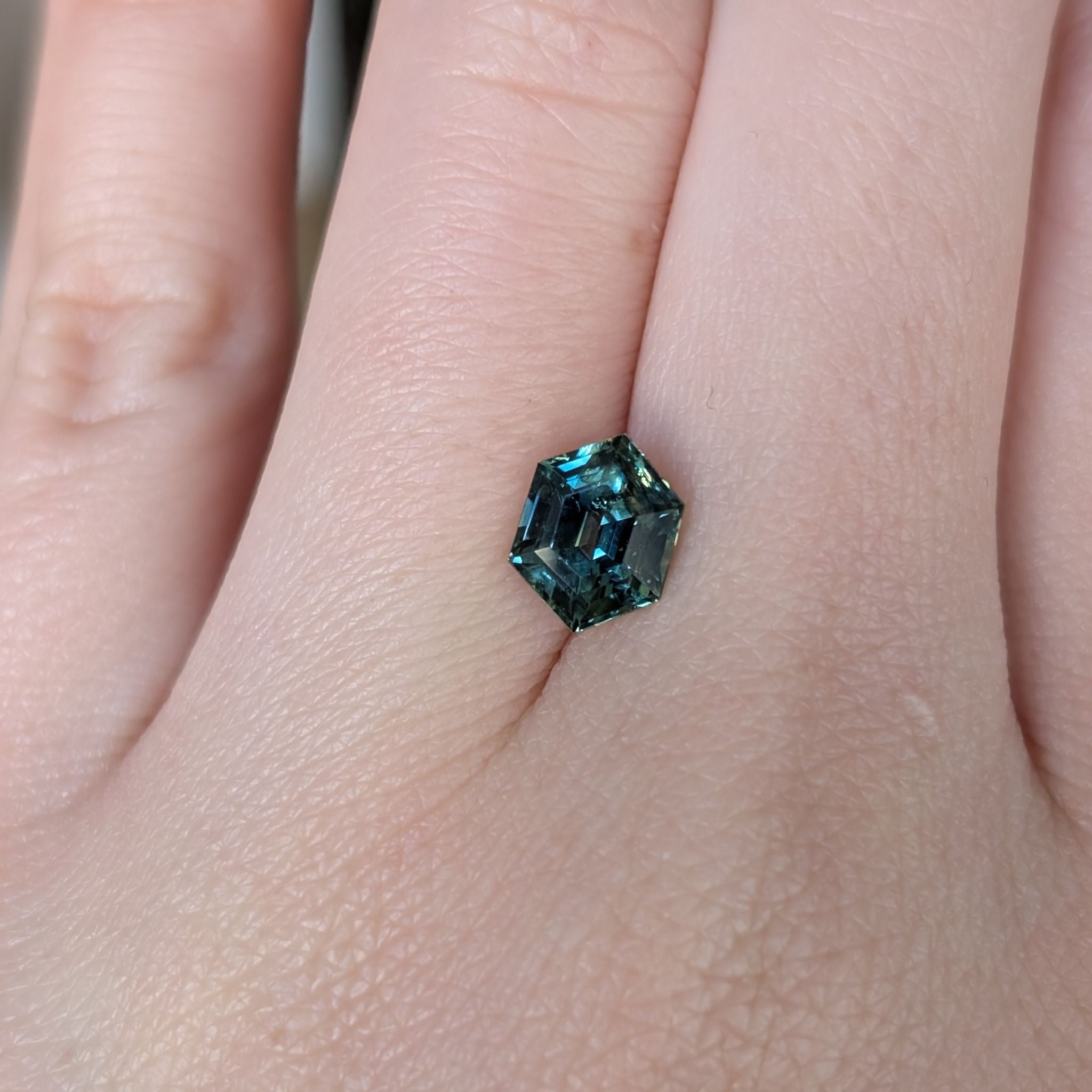 Hexagon sapphire from Subera, Queensland on hand