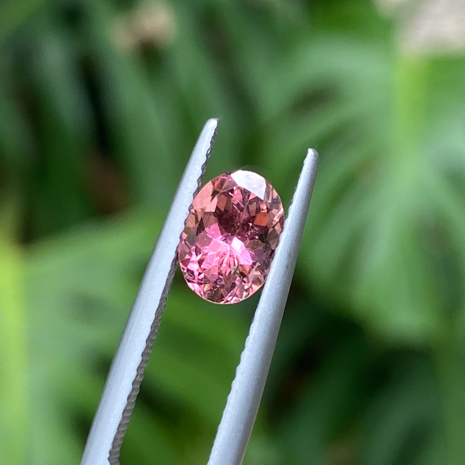 Oval cut tourmaline with peach and pink bicolour hues