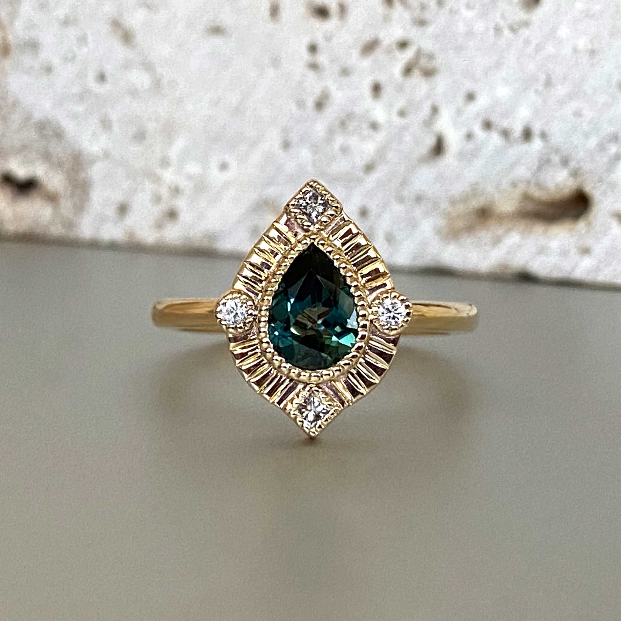 Pear halo engagement ring with ethically sourced Australian sapphires