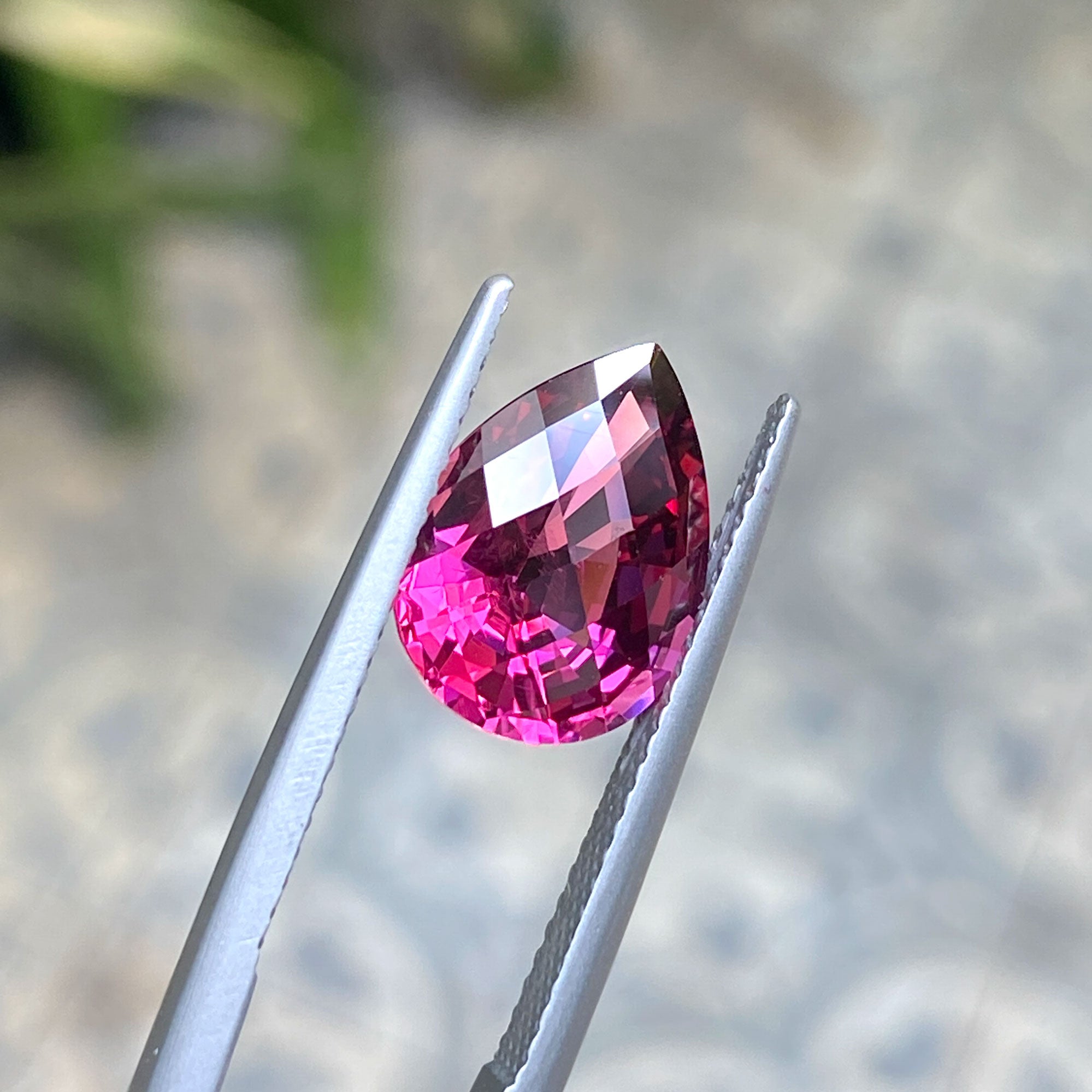 Rich burgundy pear-shaped garnet in a checkerboard cut