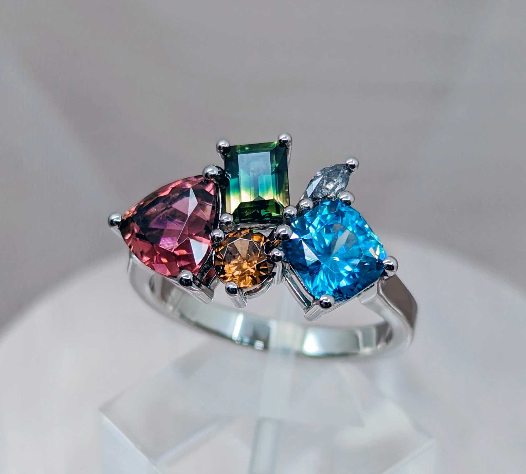 Alternative and non traditional gemstone engagement ring with sapphire, zircon, tourmaline and salt and pepper diamond