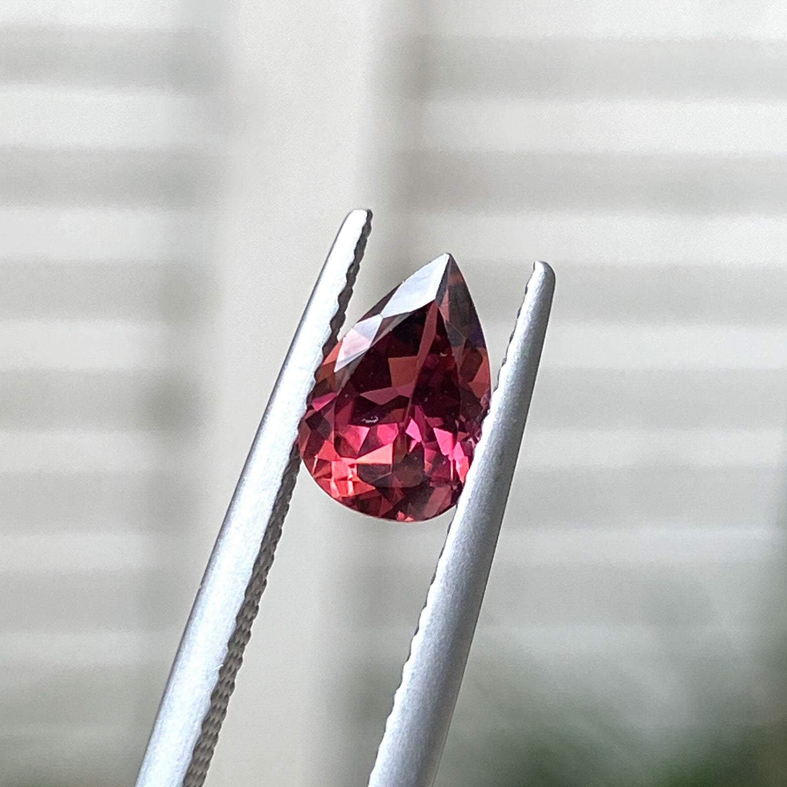 Teardrop-shaped red tourmaline gemstone