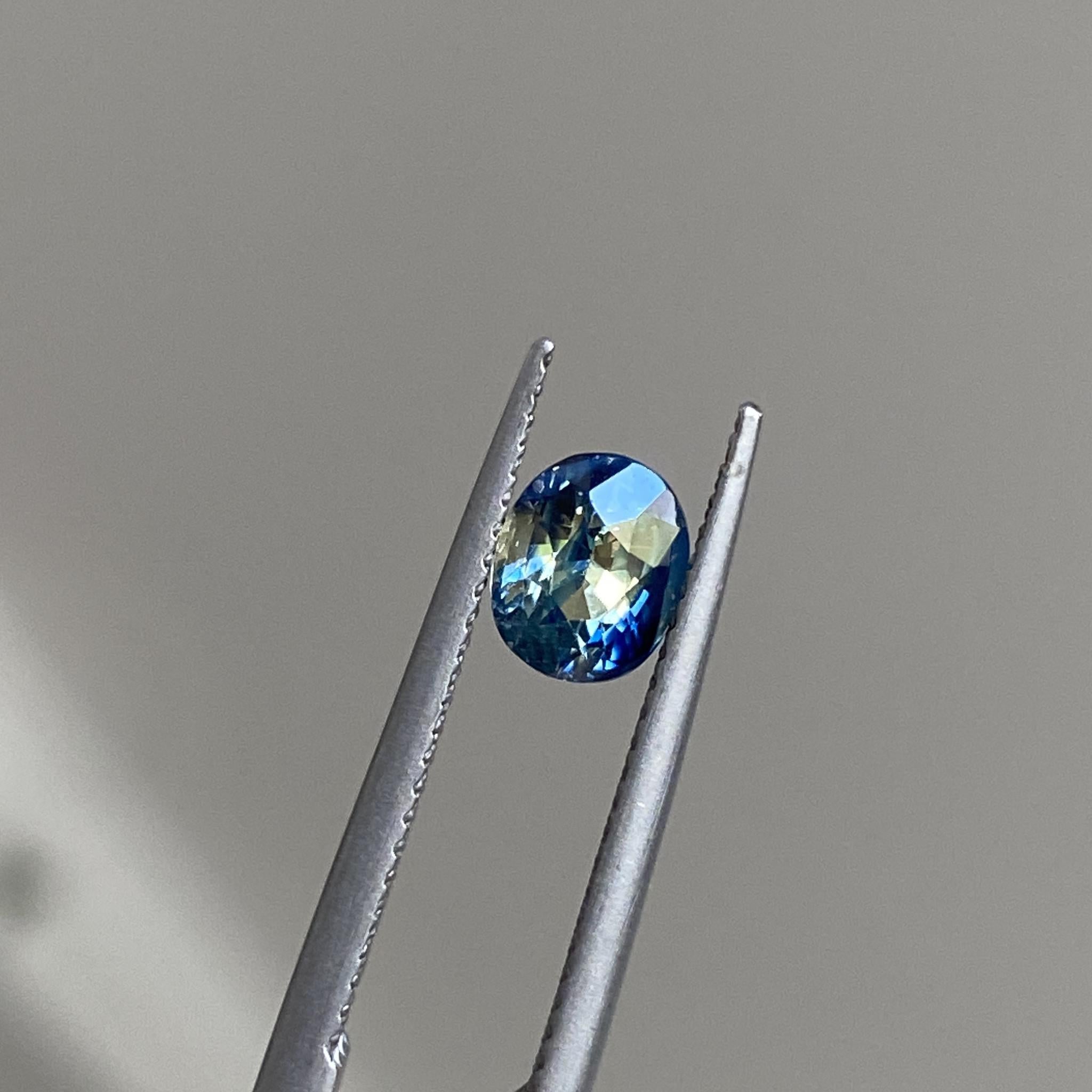 Oval cut bicolour yellow and blue parti sapphire, front view highlighting its dual-toned brilliance.