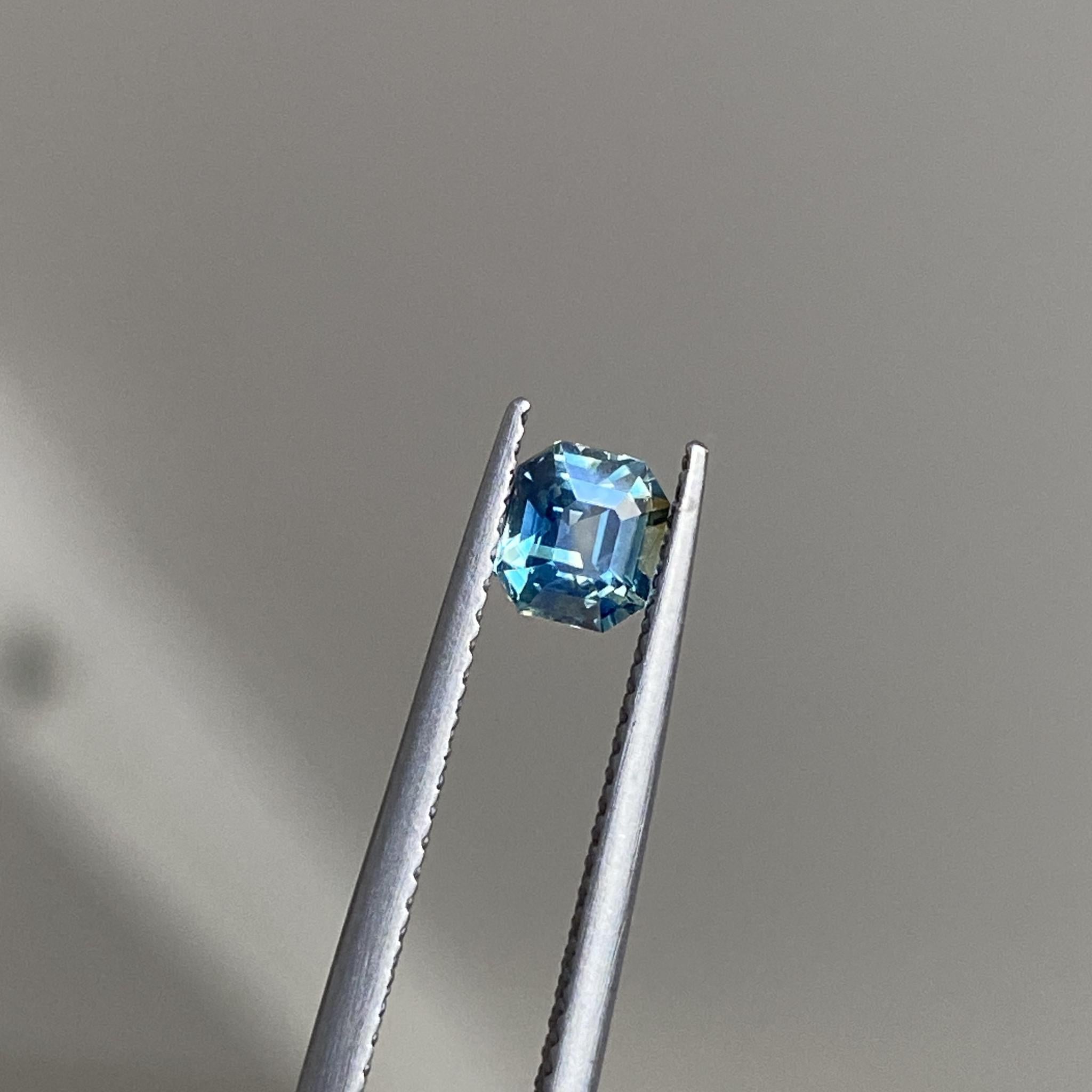 Dream On Asscher-cut blue sapphire showcasing its unique geometric design.