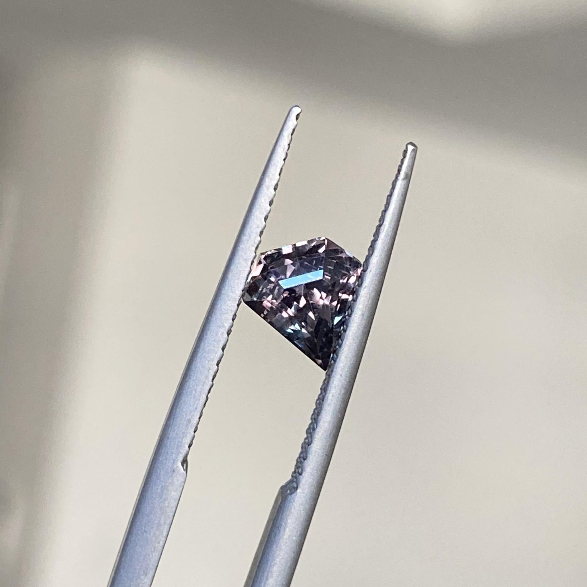 Duality shield sapphire glowing in burgundy and teal under light changes.