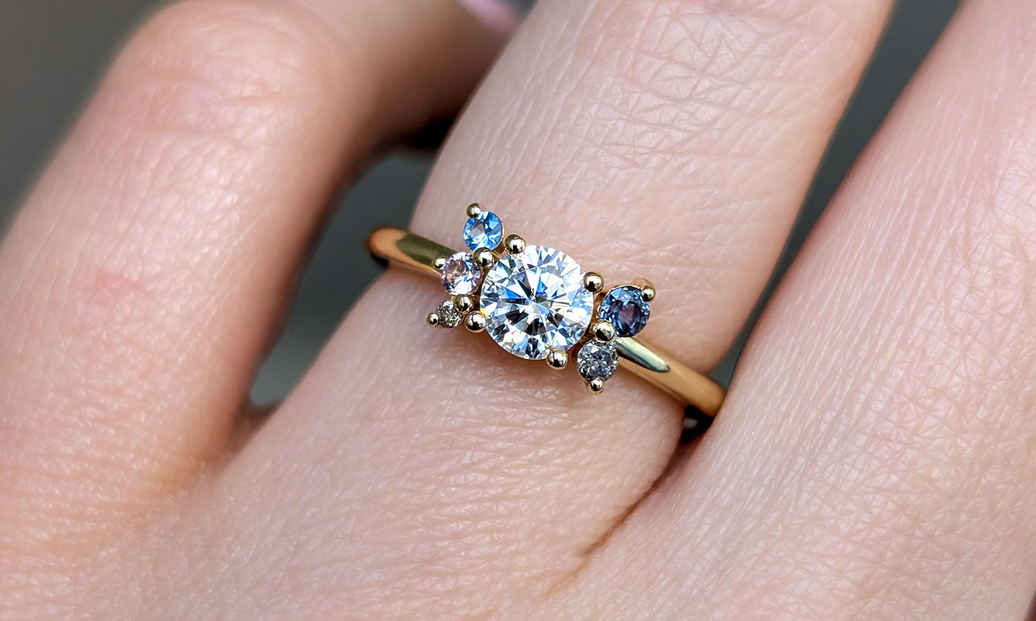 Gold ring with a diamond and blue sapphire gemstones