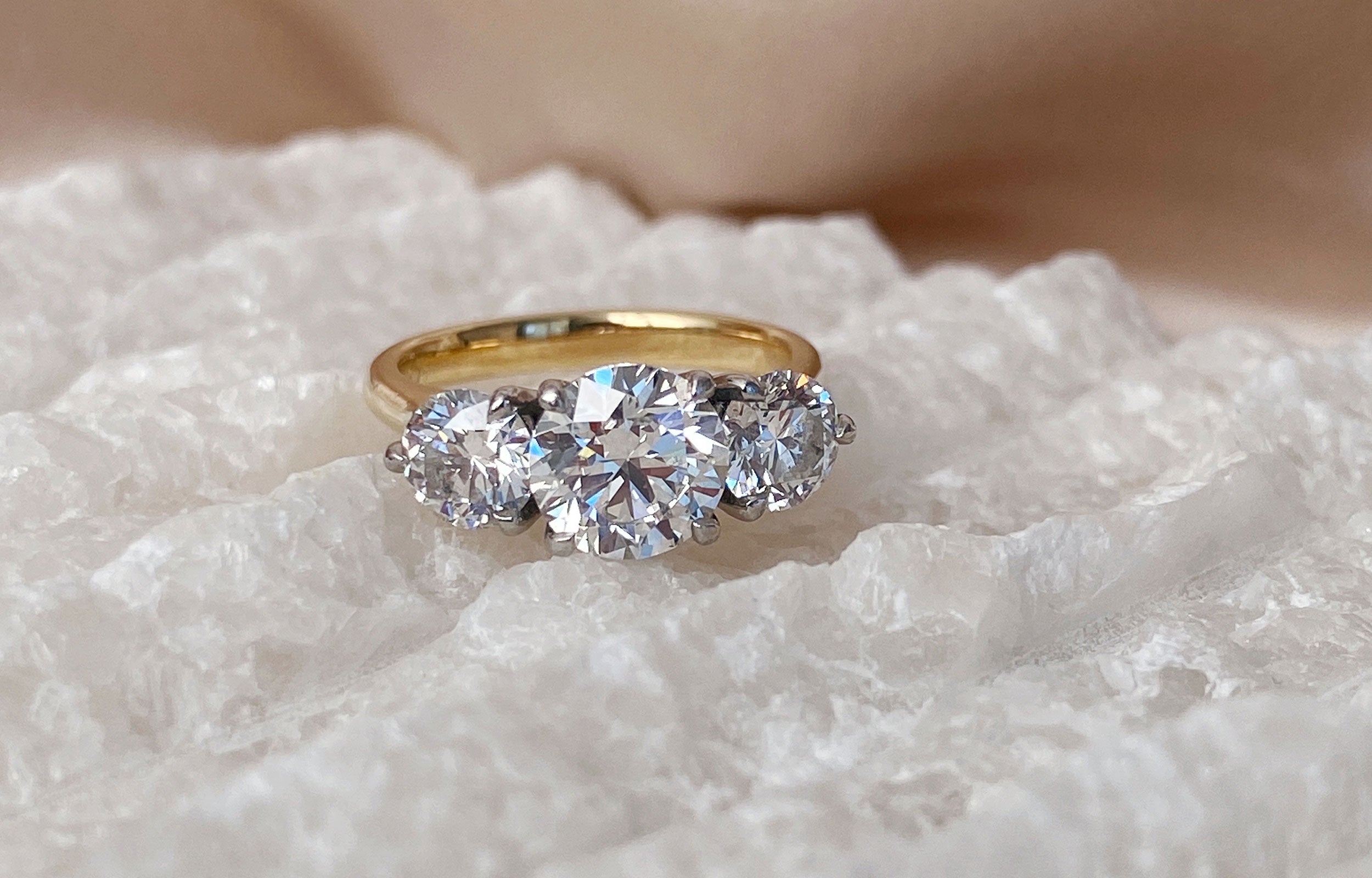 Lab grown diamond three-stone ring in yellow gold and platinum