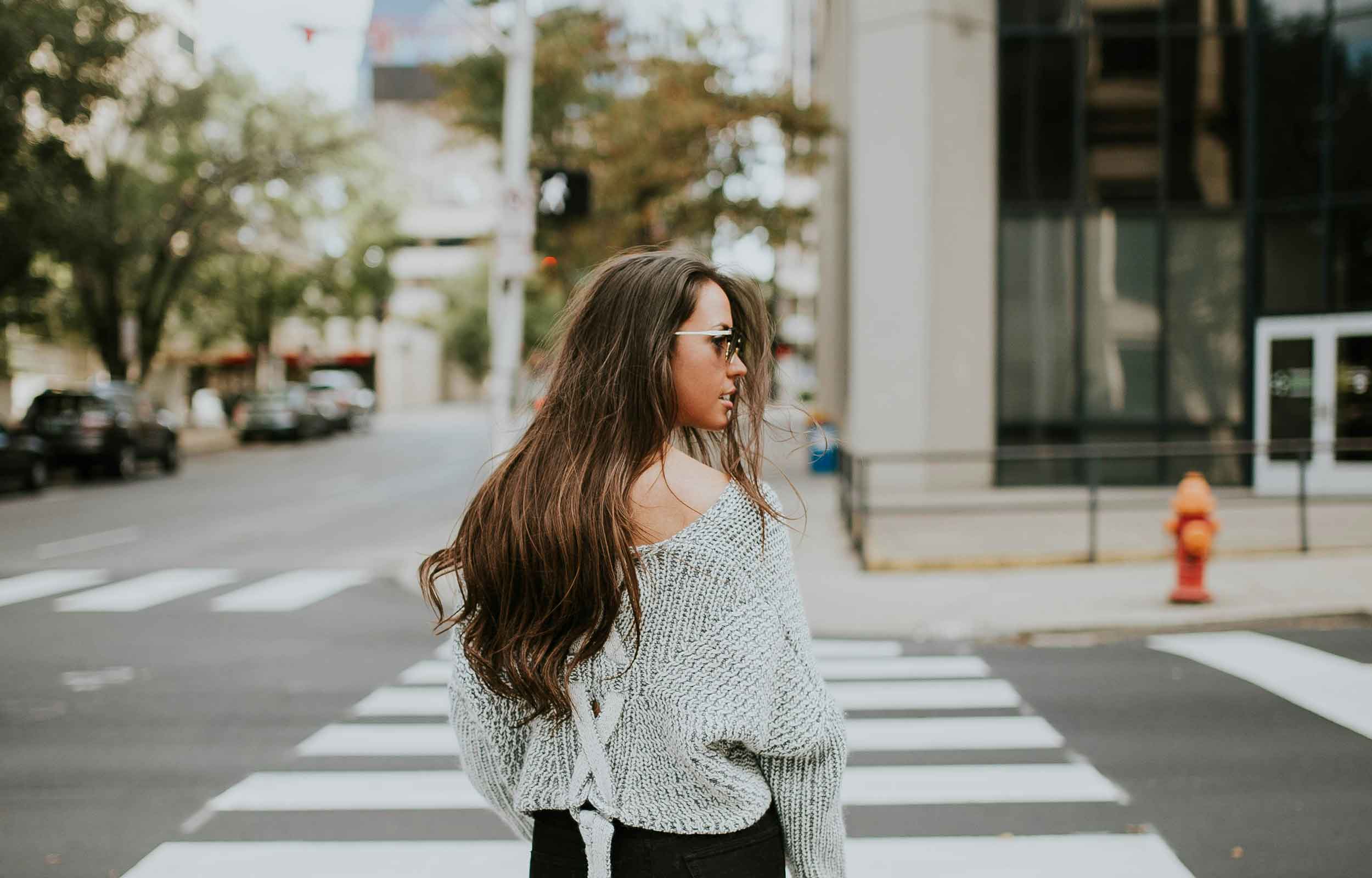 Woman crossing road, image by Brooke Cagle