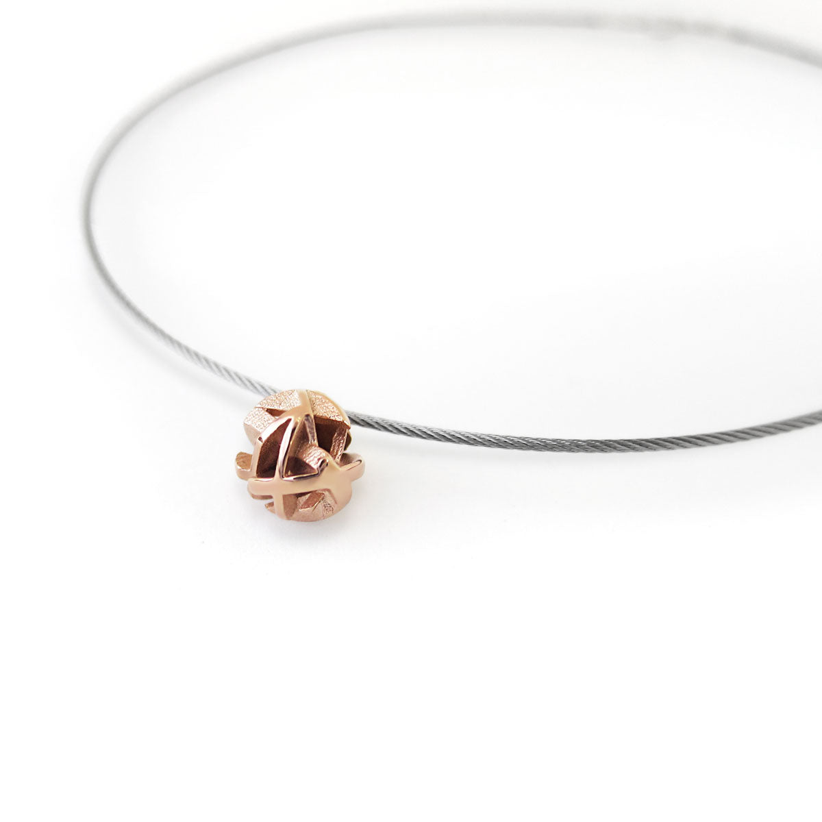 3D printed rose gold ball necklace on stainless steel cable side view