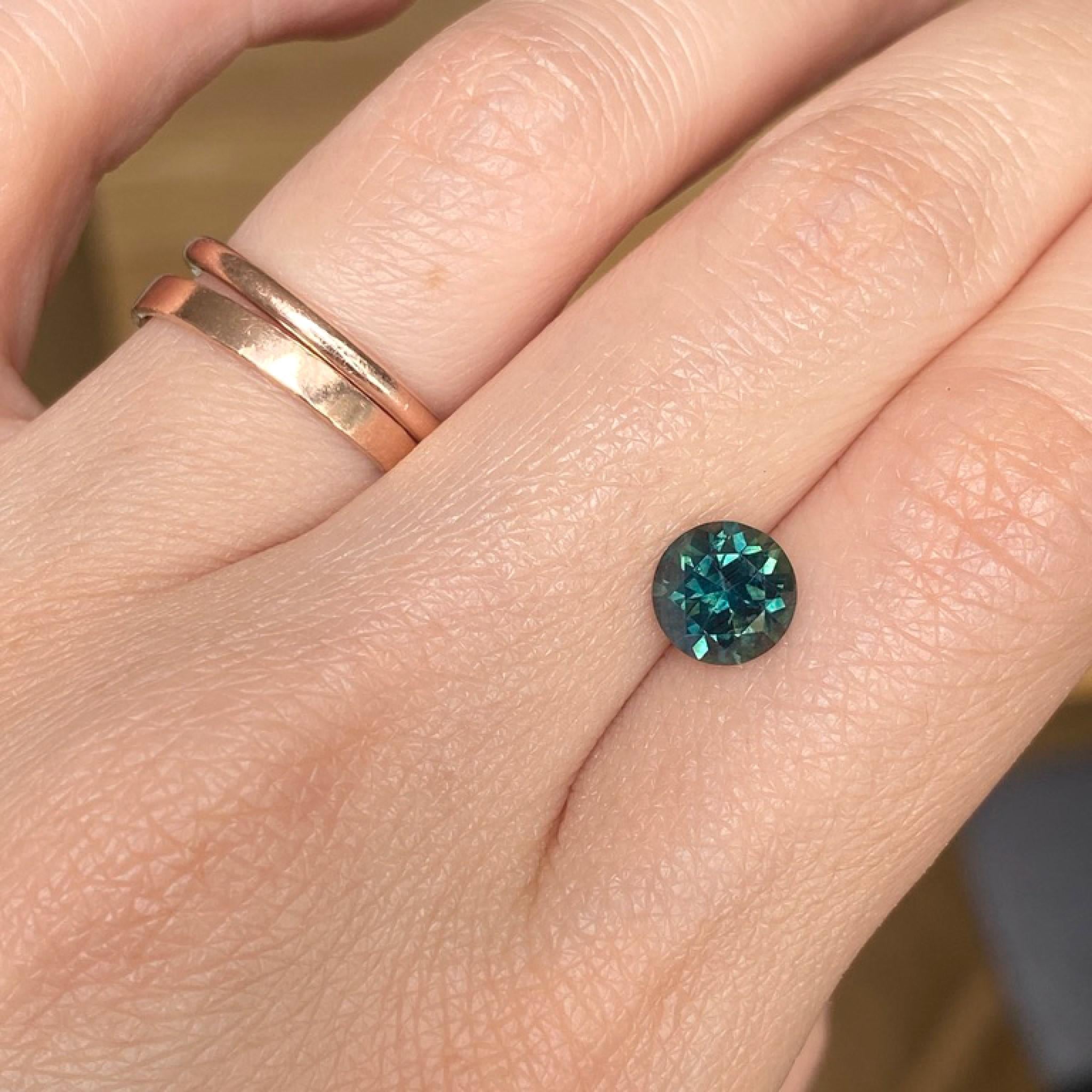 Australian teal sapphire on hand