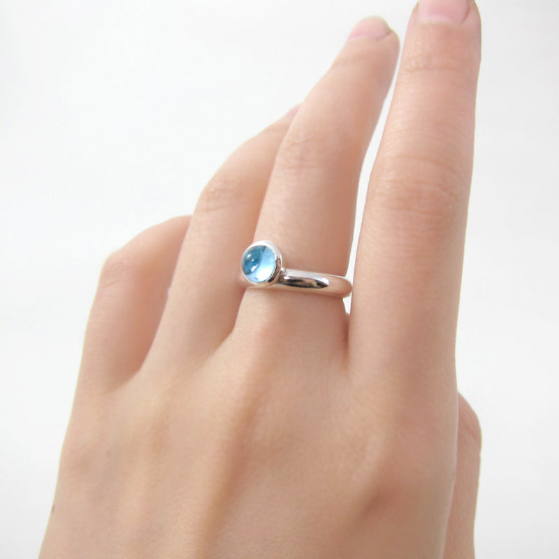 Full Circle topaz cabochon ring worn