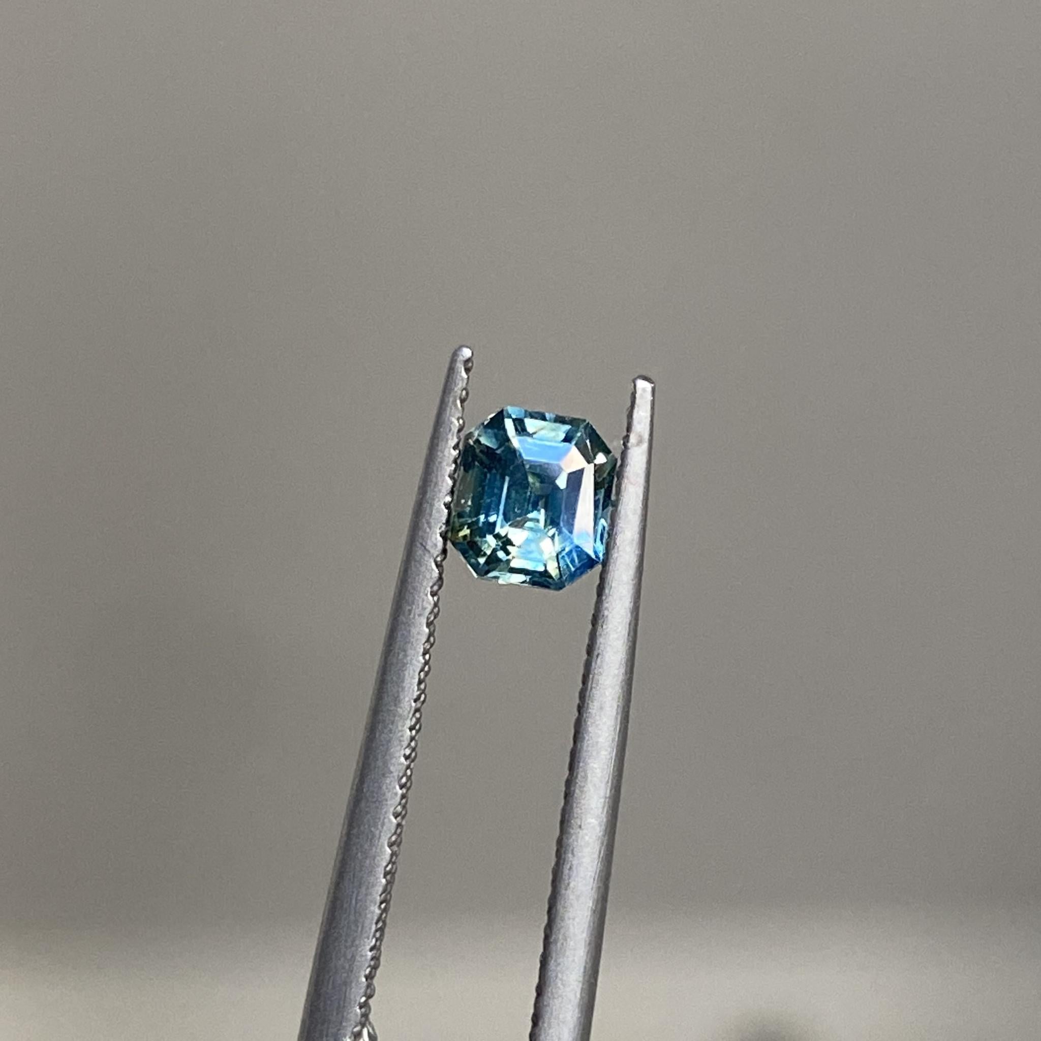 Reverie emerald-cut sapphire showcasing its teal and yellow hues