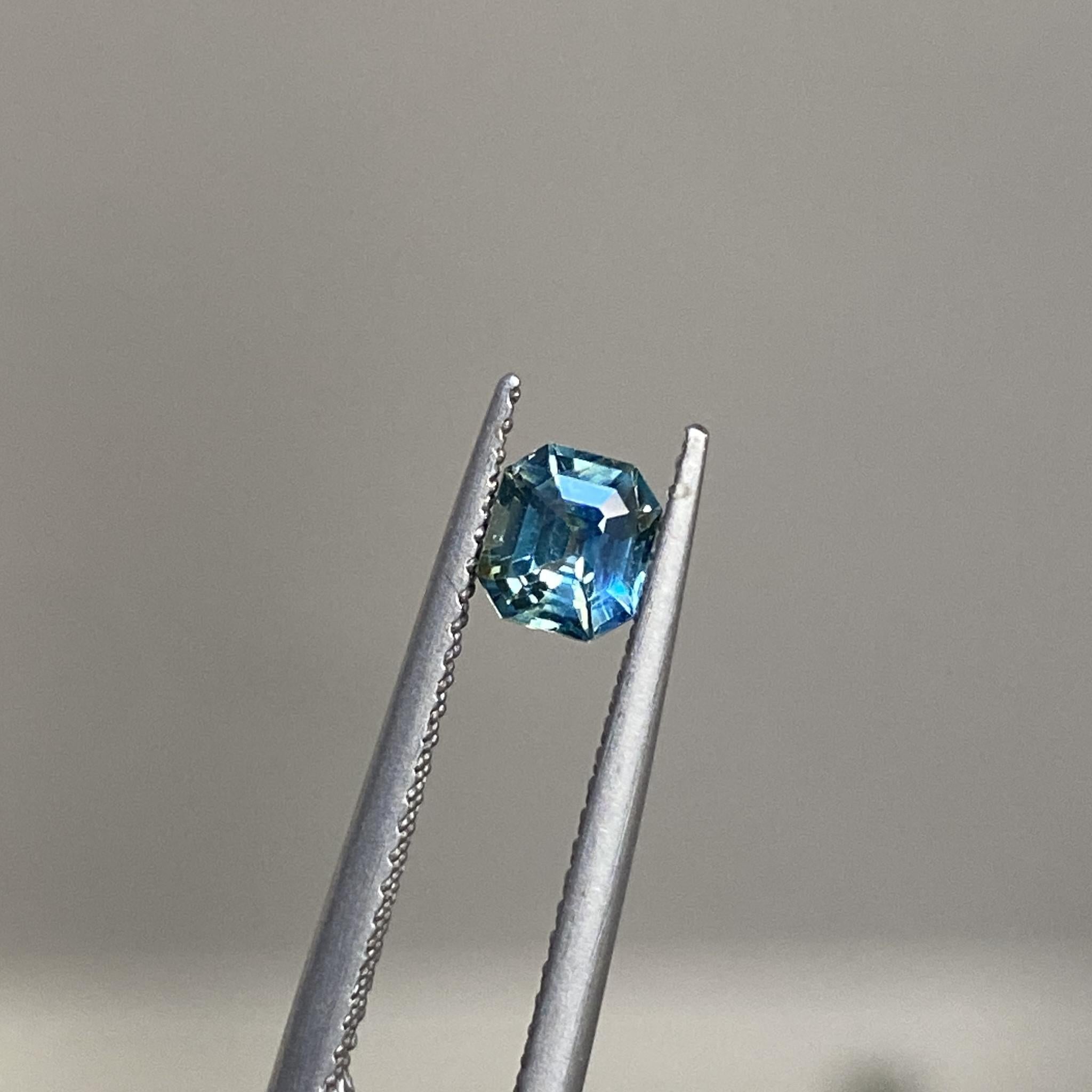 Reverie sapphire highlighting its vivid teal and yellow tones under light