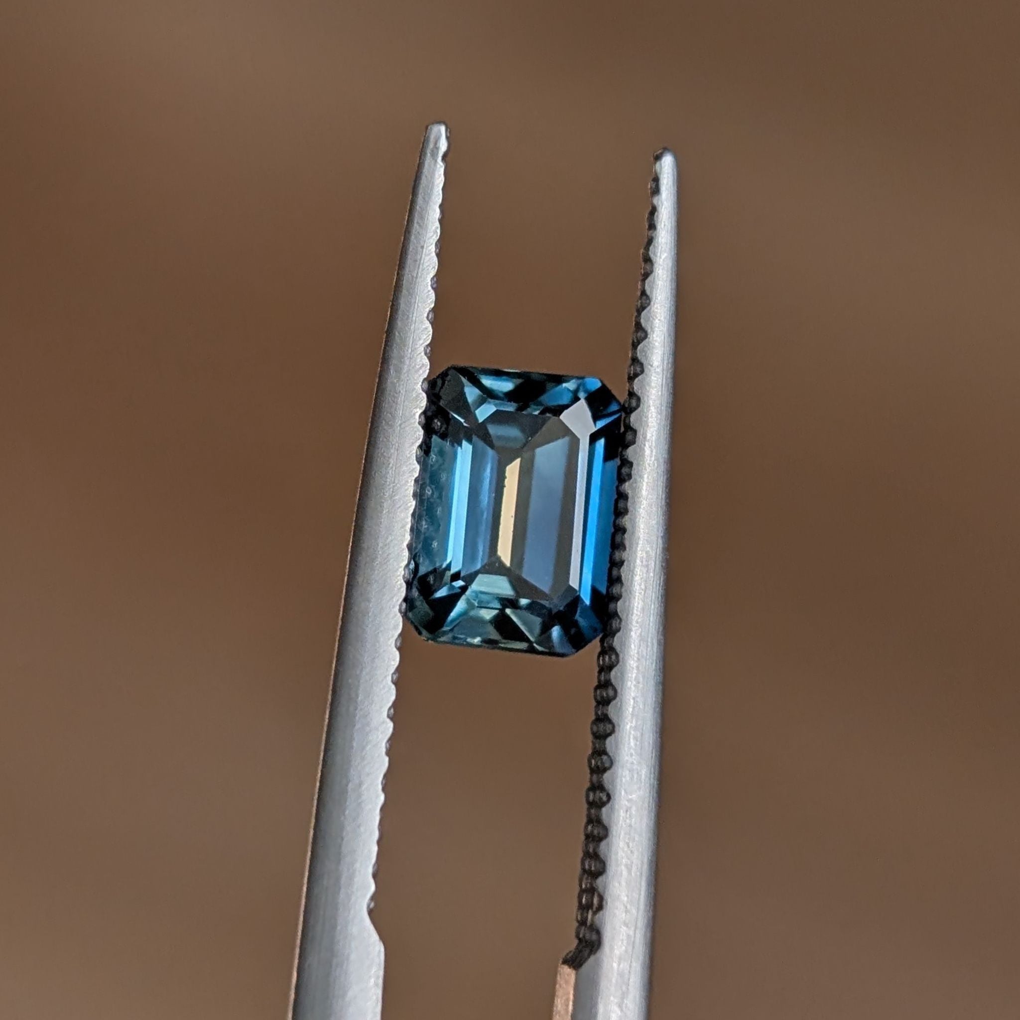 Blue emerald cut sapphire with details