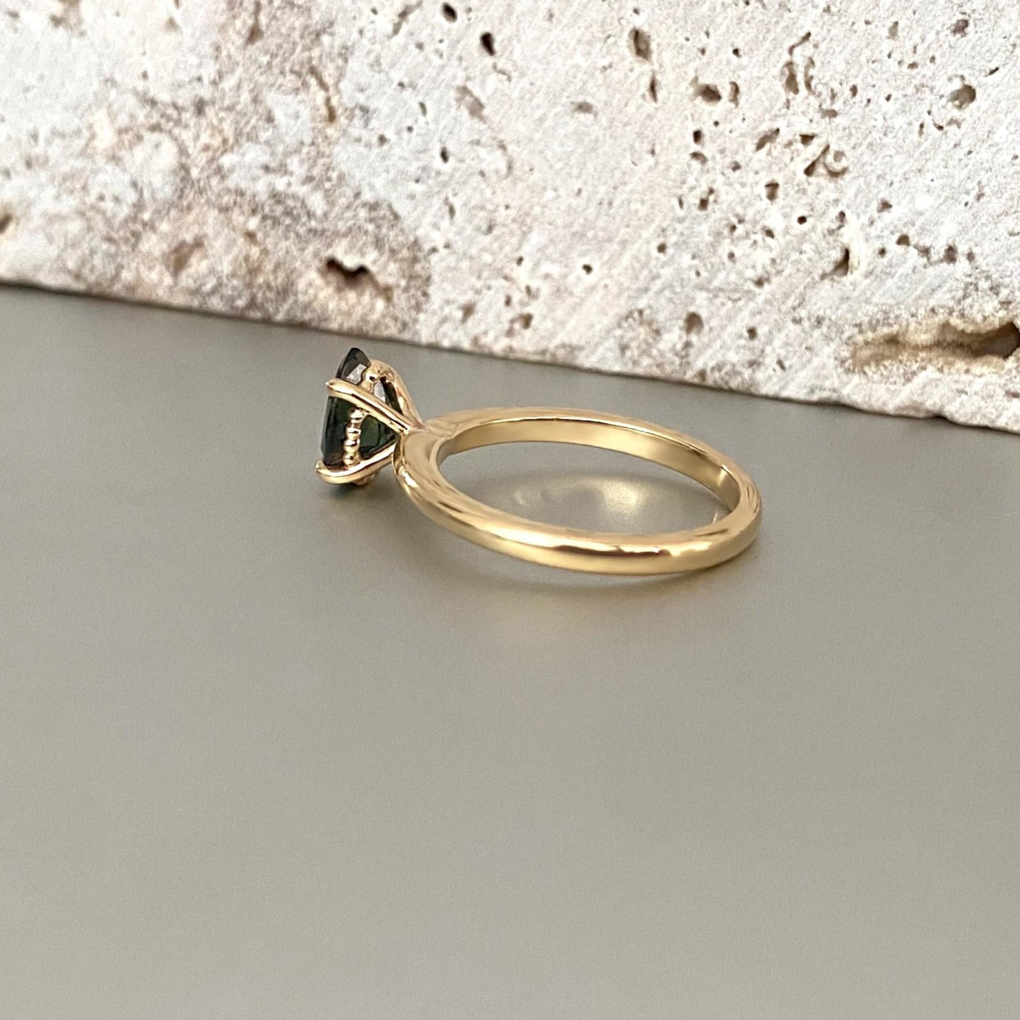 Drop shaped solitaire ring in yellow gold side view 