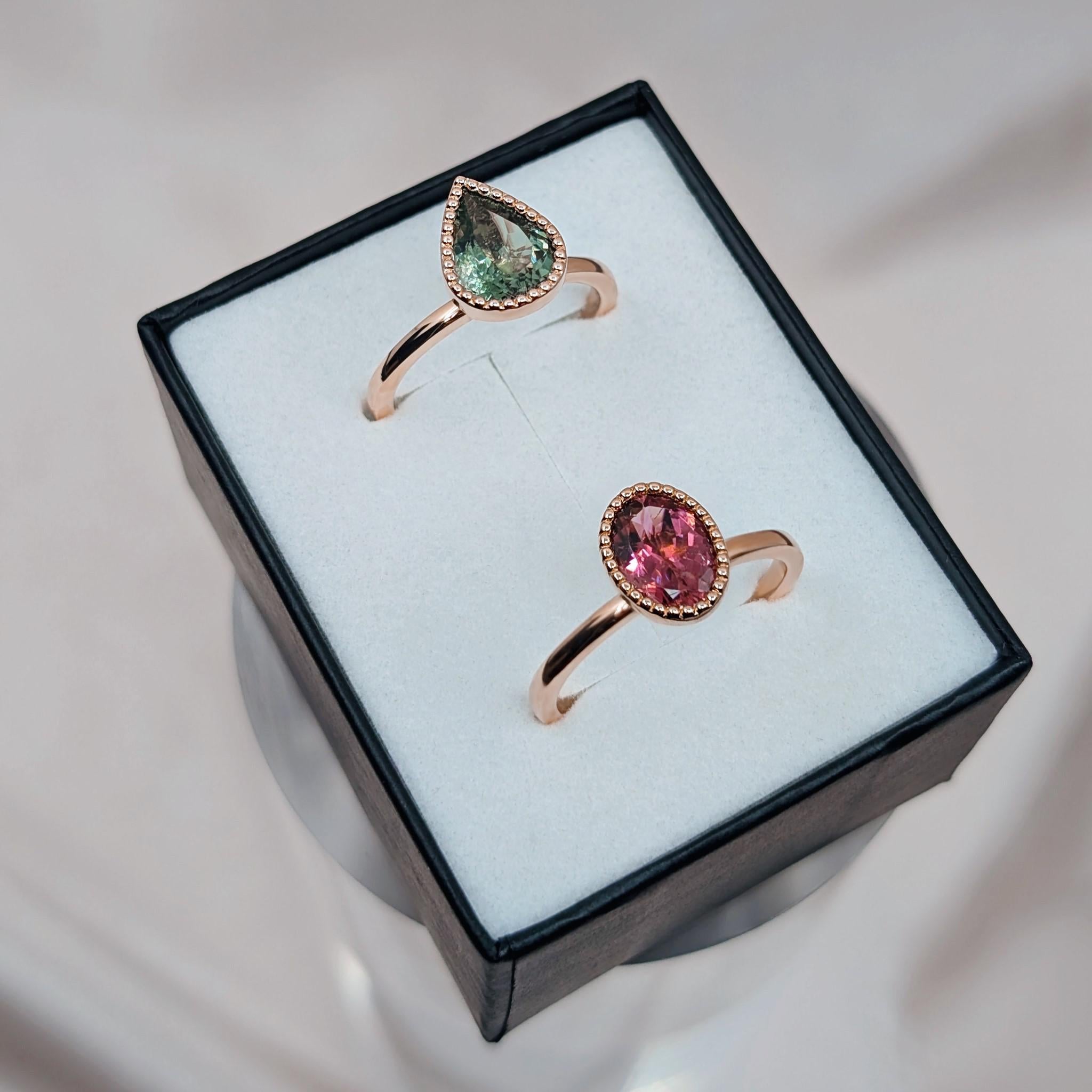 green and pink tourmaline milgrain rings in a box