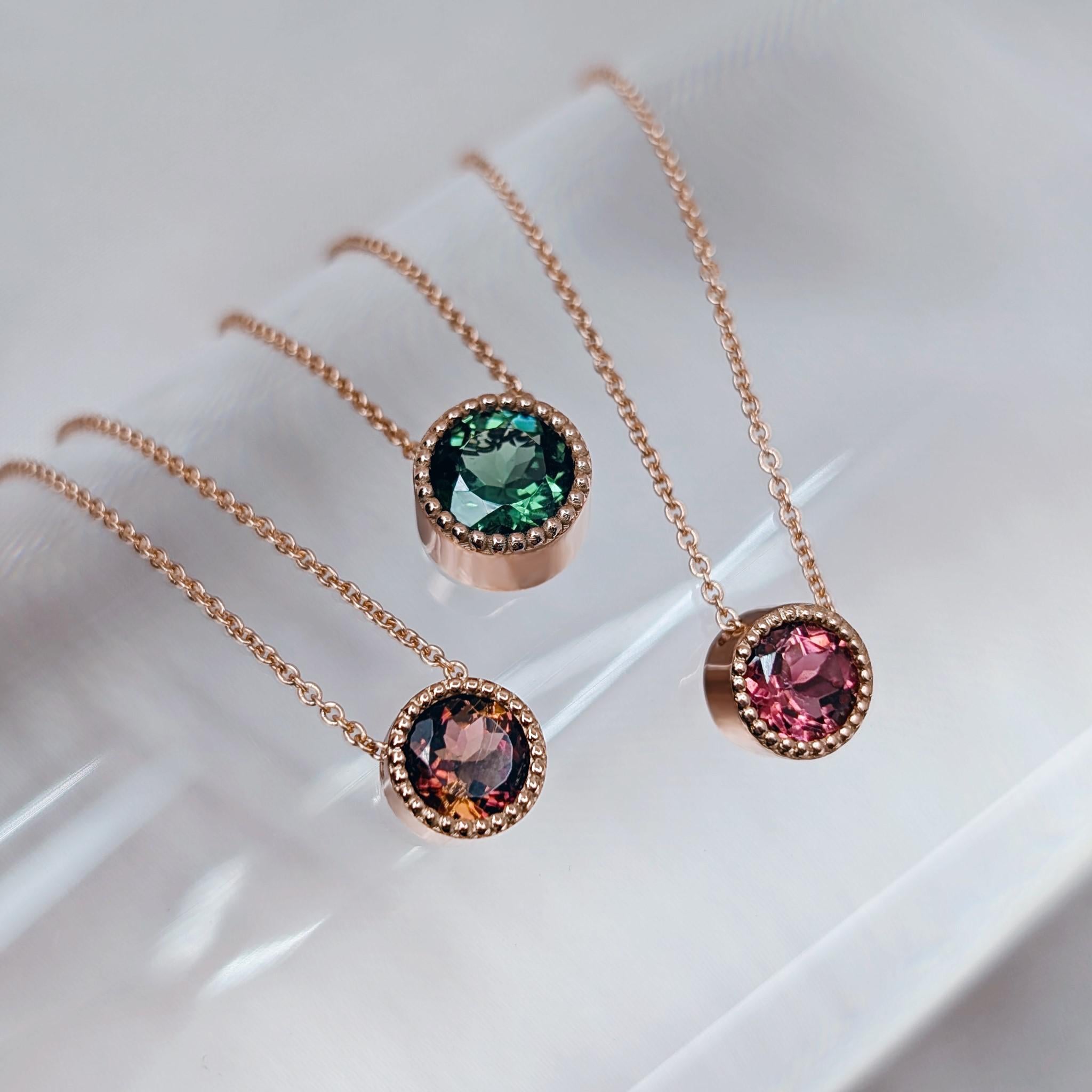 gold necklaces with green pink and  bicolour tourmalines