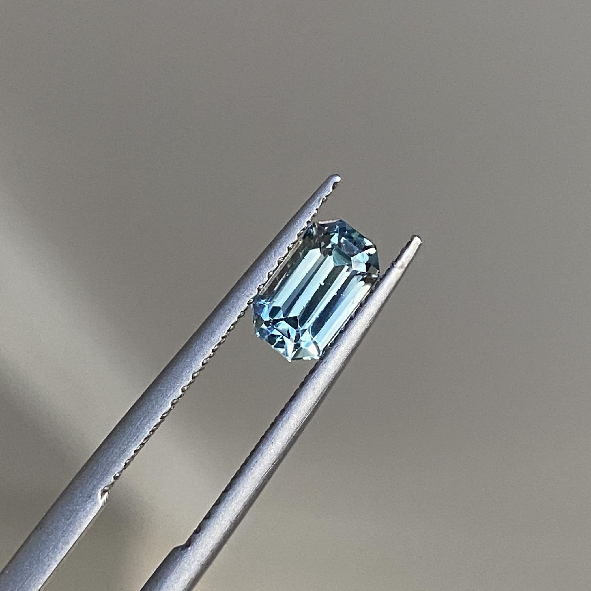 Ice blue sapphire at a slight angle, highlighting its reflective facets.