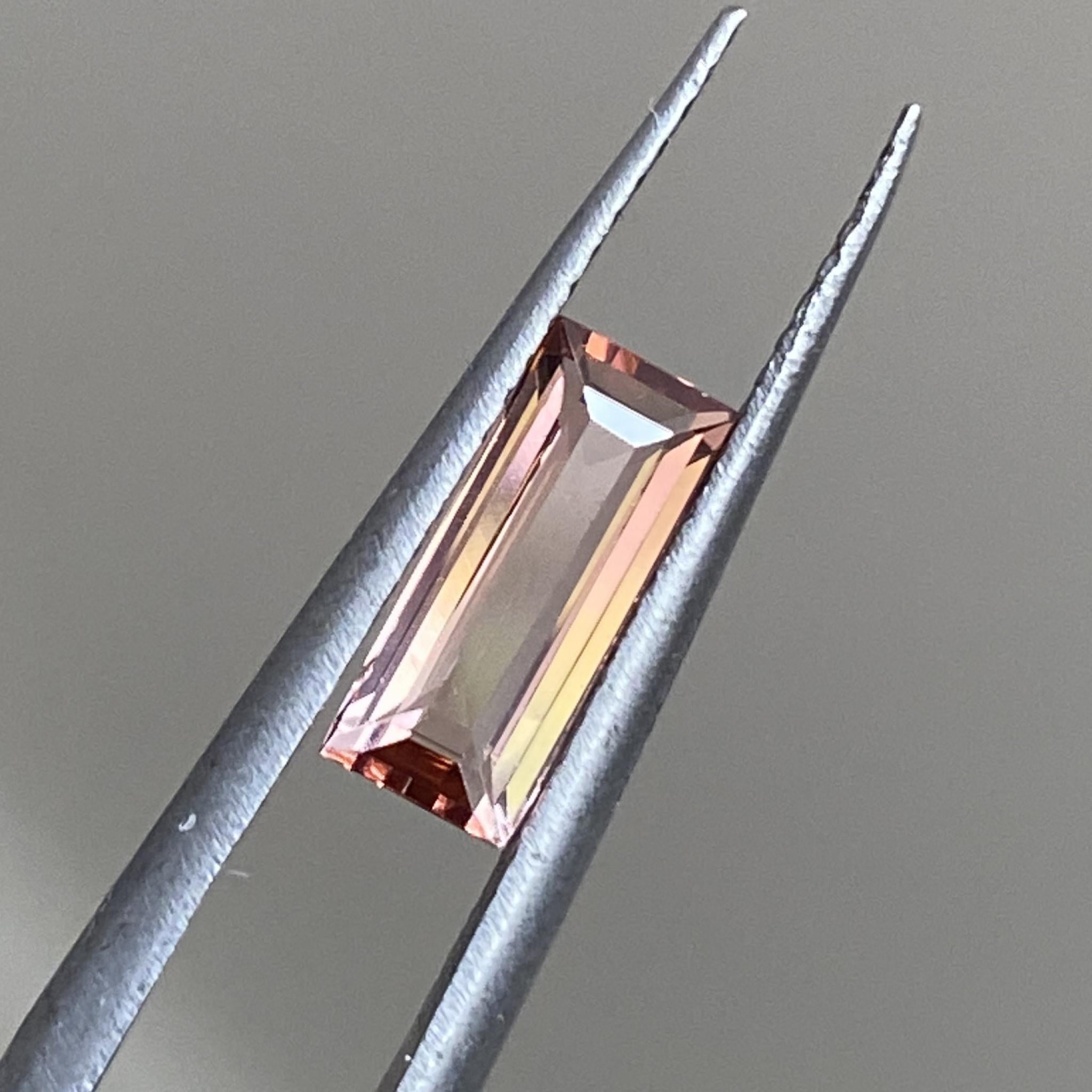 Ember bicolour tourmaline radiating under soft lighting