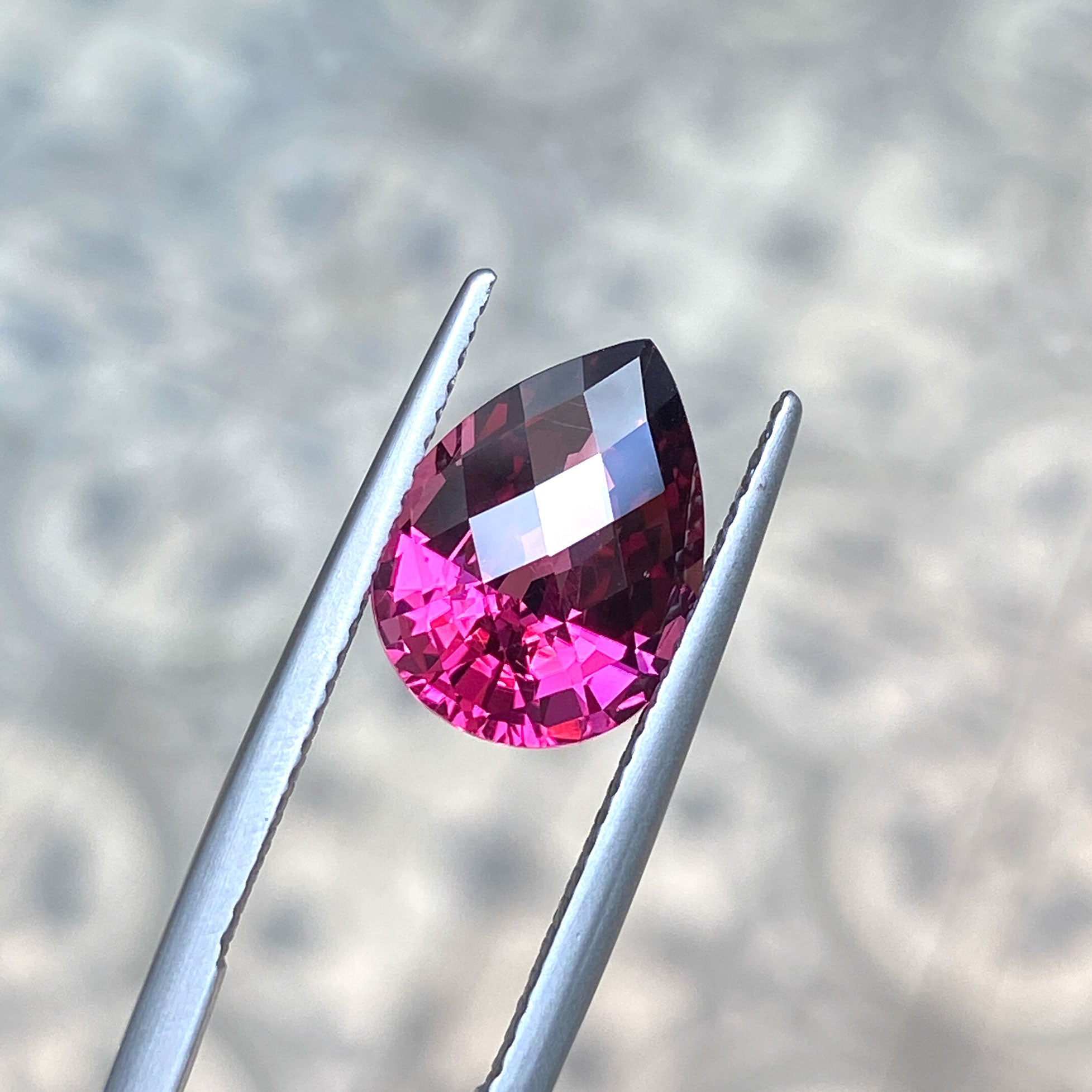 Pear shaped checkerboard cut garnet