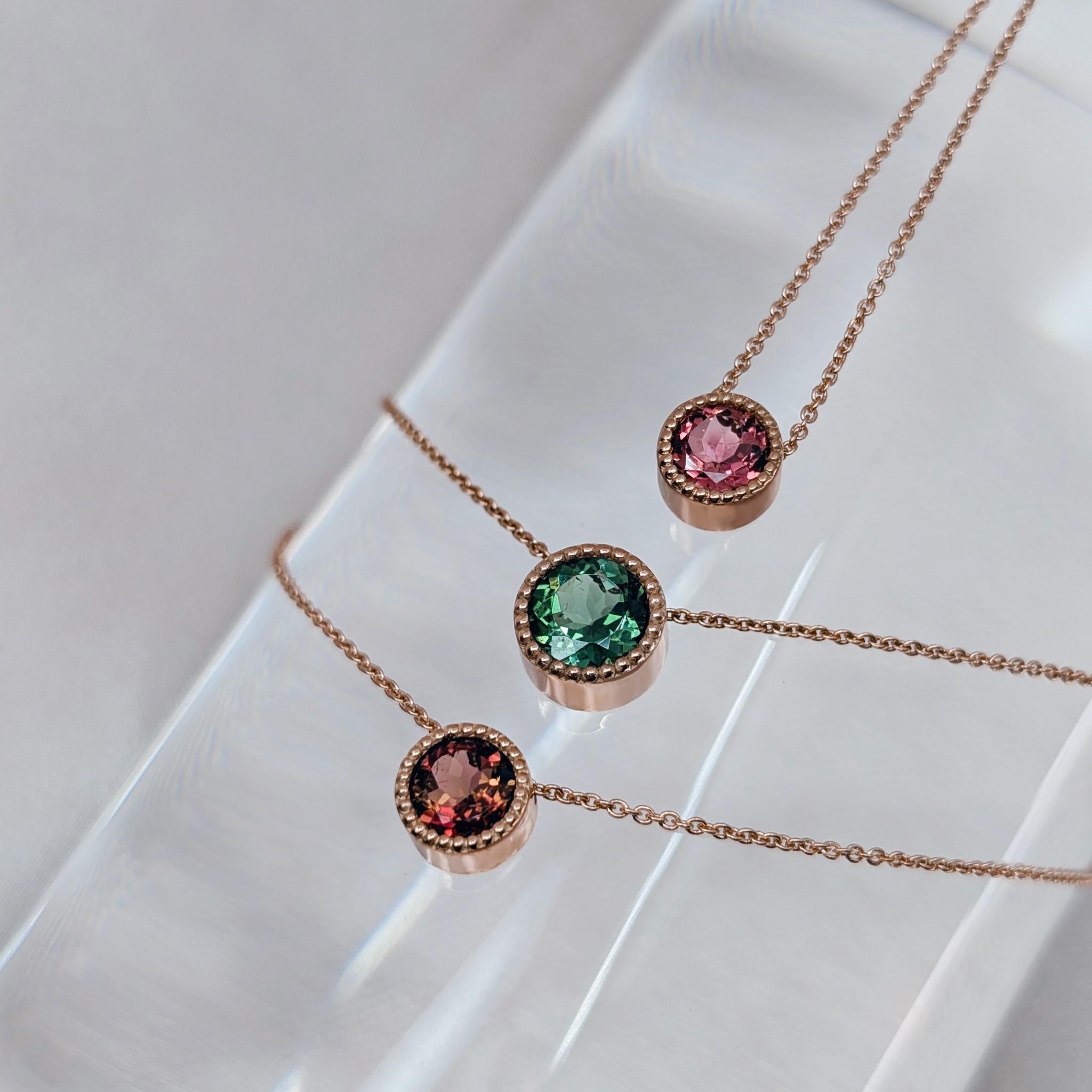 layered necklaces with green pink and  bicolour tourmalines