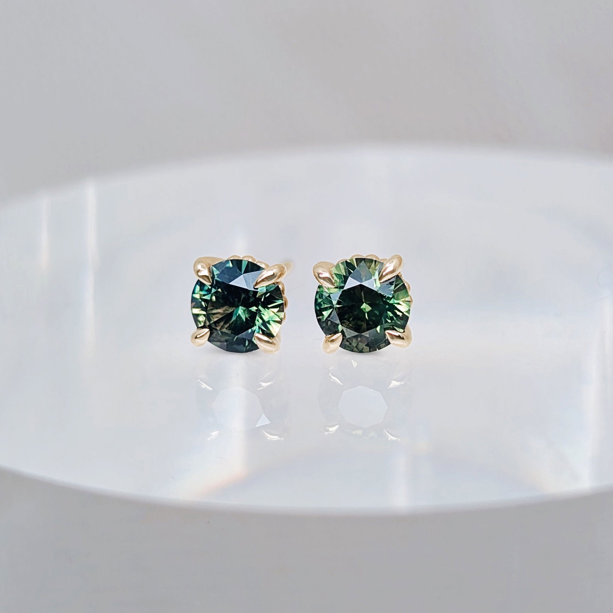 Teal sapphire solitaire studs by Fairina Cheng