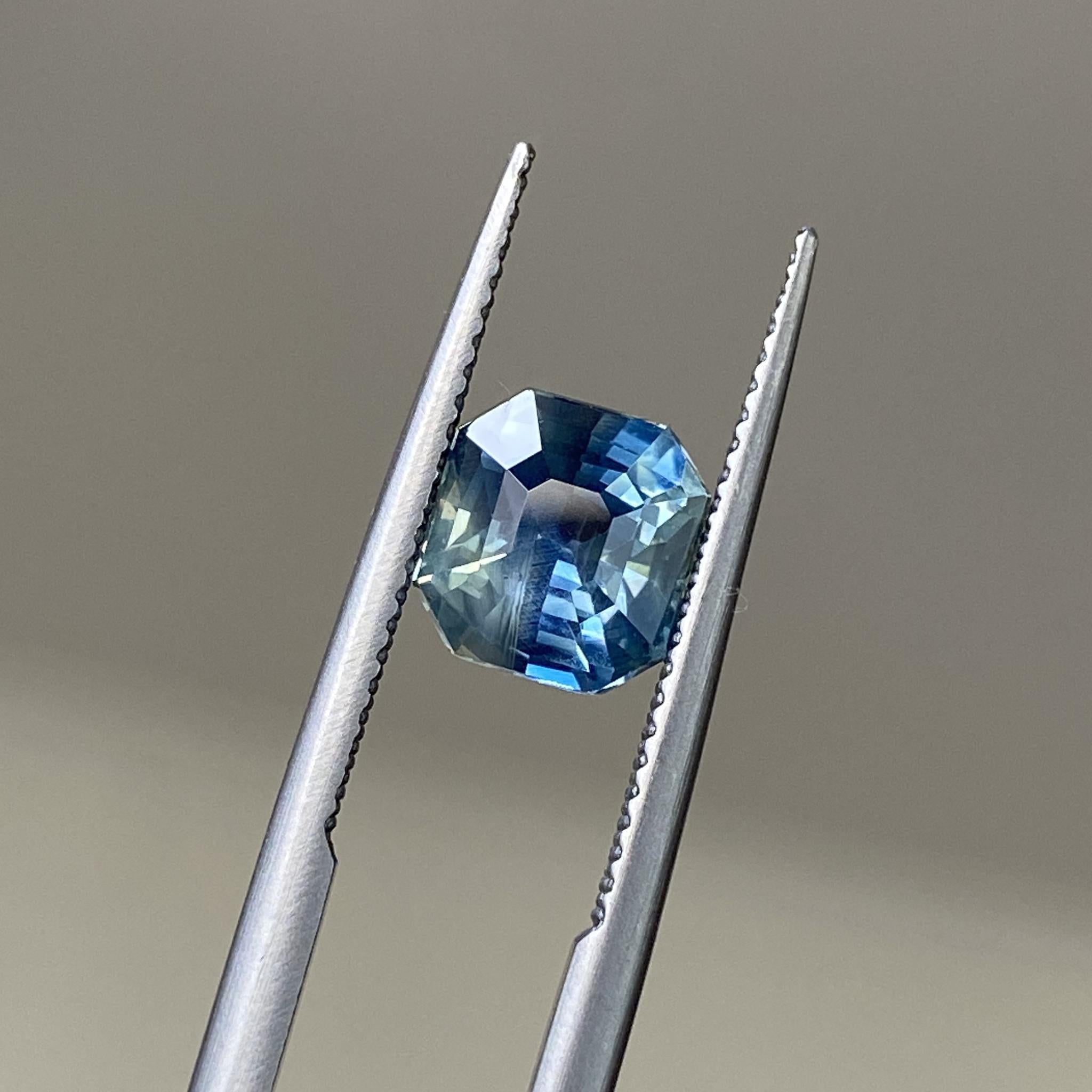 Close-up of the silky teal sapphire, emphasizing the depth and clarity of its Asscher cut.