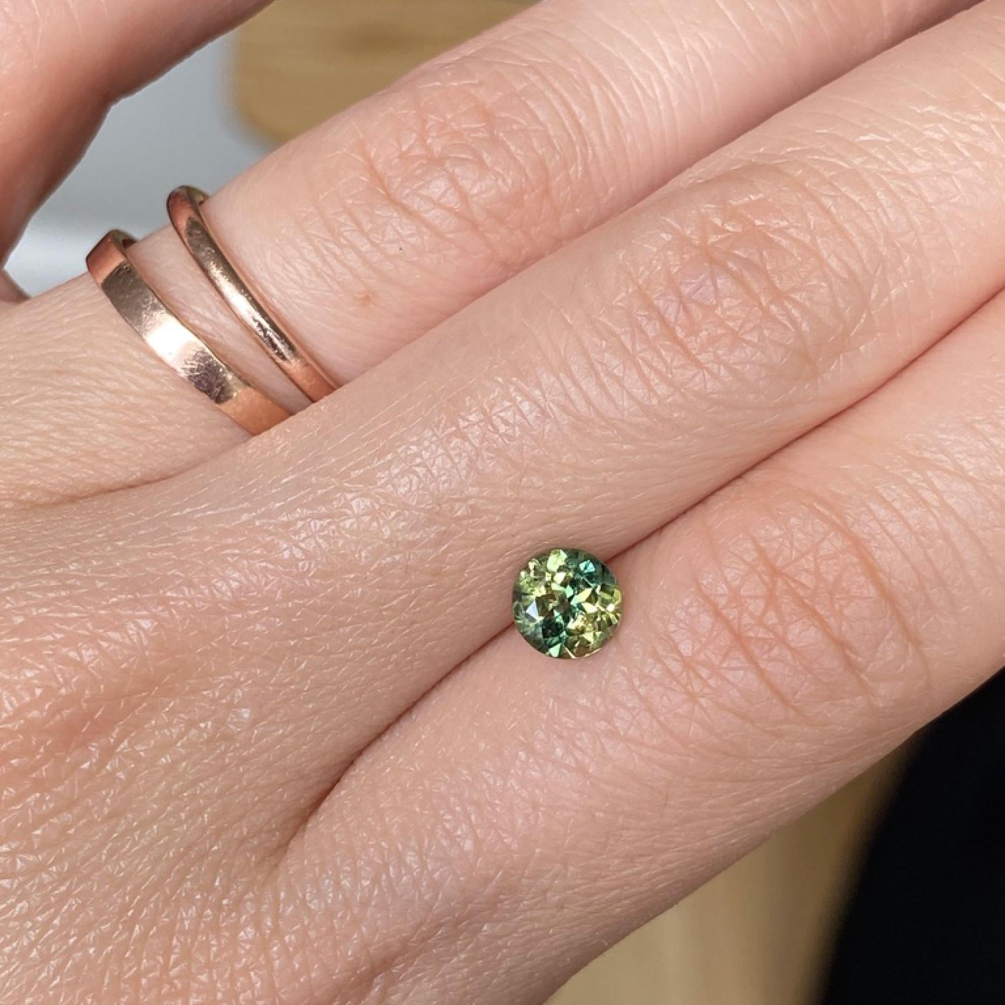 Yellow green Australian parti sapphire on hand