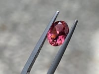 Warm orange pink oval tourmaline gemstone