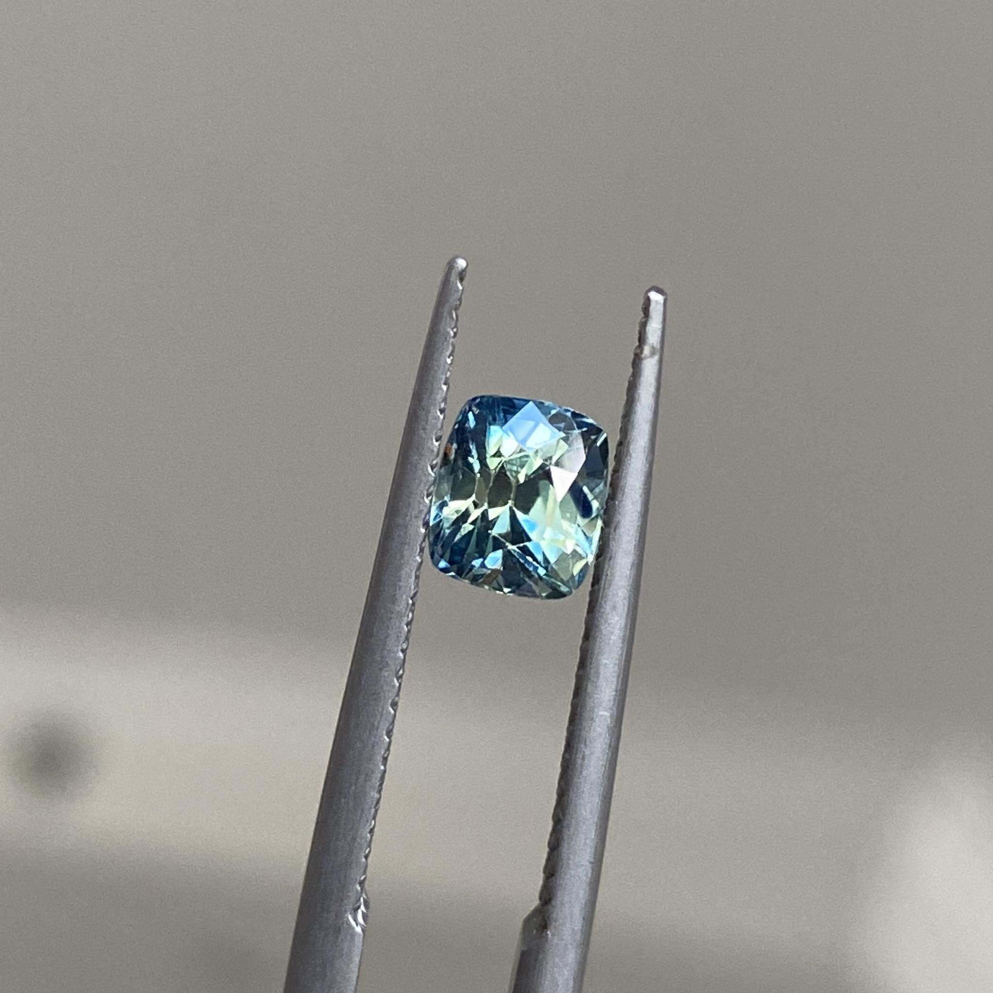 Blue Mojito sapphire displaying its stunning teal colour and elegant cushion cut