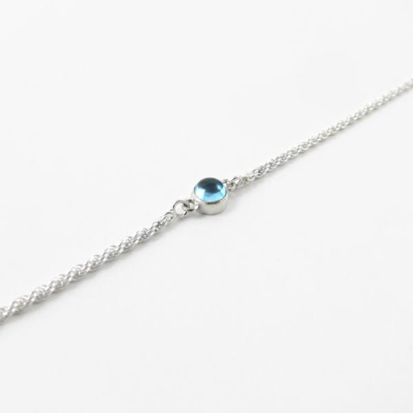 Blue topaz domed gemstone bracelet with a sterling silver rope chain