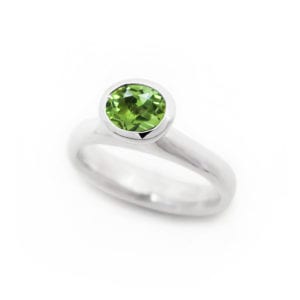 Oval peridot ring with bright green gemstone