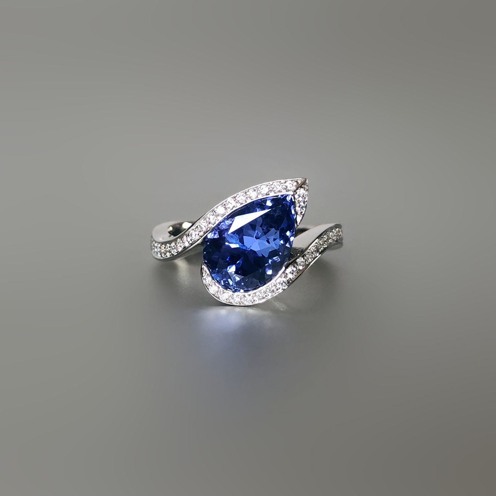 Platinum, Ceylon sapphire and diamond swirl ring