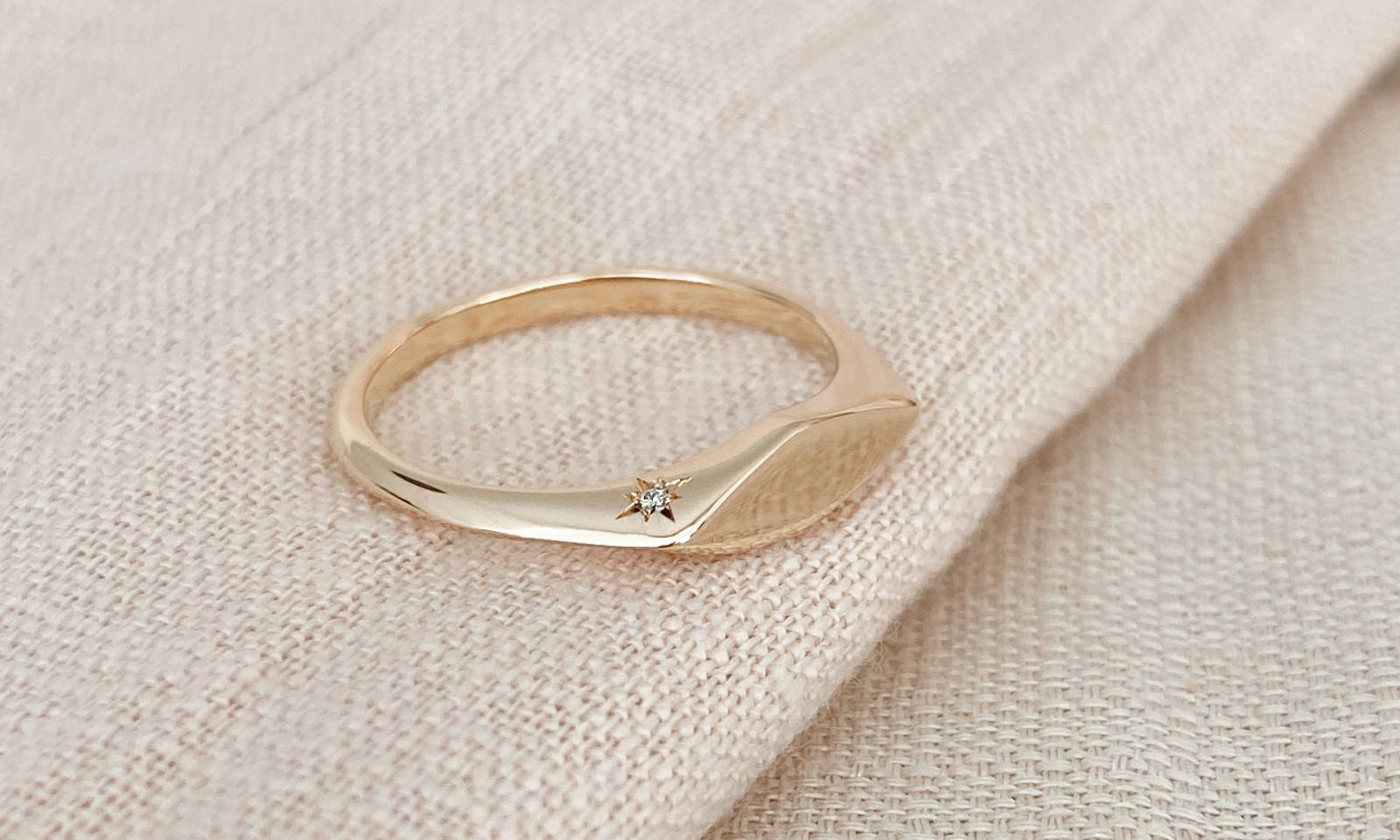 Custom gold signet engagement ring with diamond