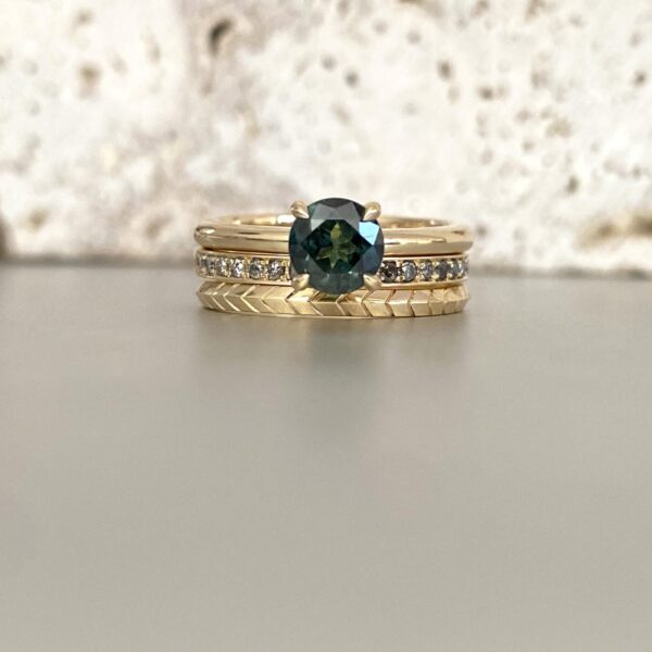 Stacked solitaire commitment ring with untraditional wedding bands