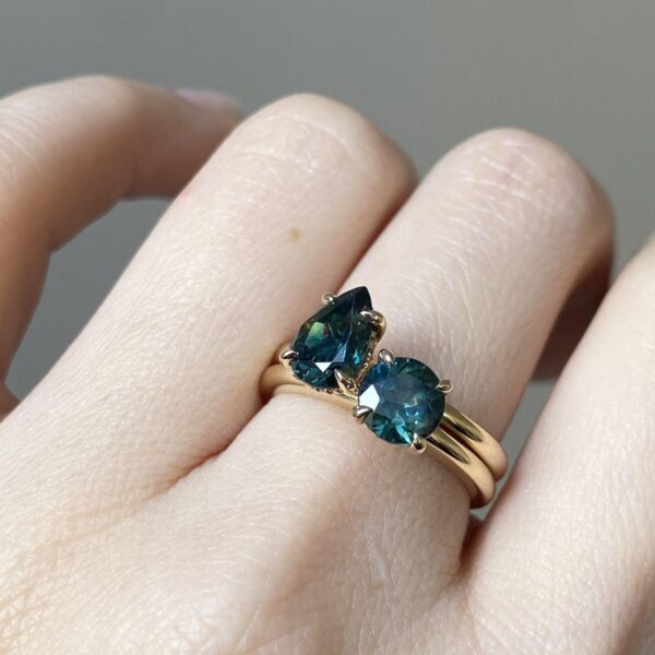 Teal sapphire and gold solitaire rings